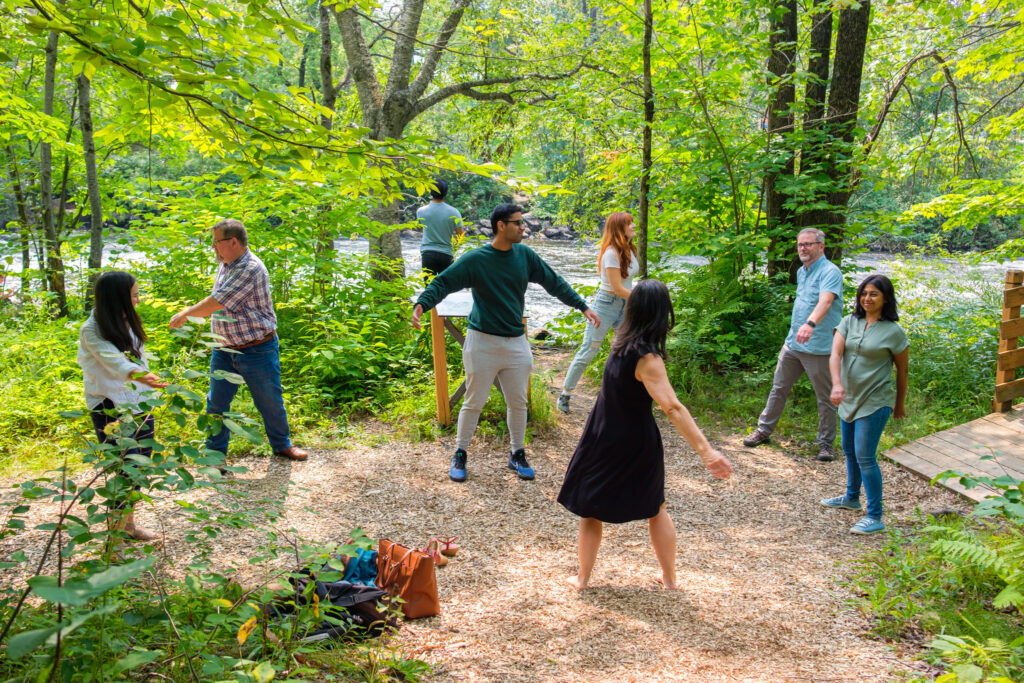 Young environmental leaders from Lawson Foundation's Youth Action & Environment Pilot Fellowship do outdoor yoga together in Quebec City.
